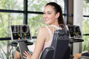 Fit woman doing exercise bike