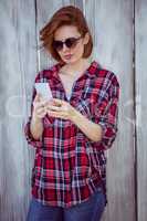 beautiful hipster woman looking at her mobile phone