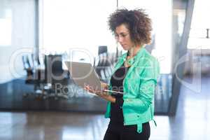 Young woman using laptop in office