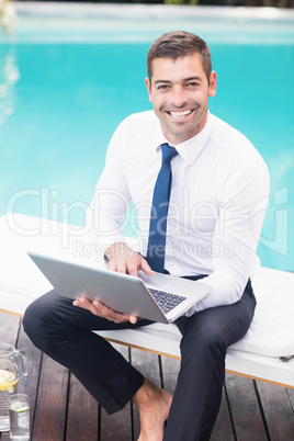 Smarty dressed man using laptop