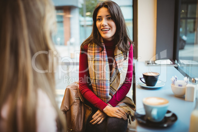 Pretty friends chatting over coffee