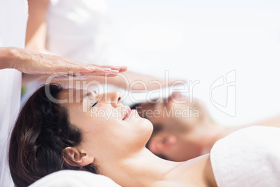 Couple receiving a head massage from masseur