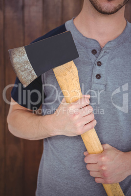 Handsome hipster holding an axe