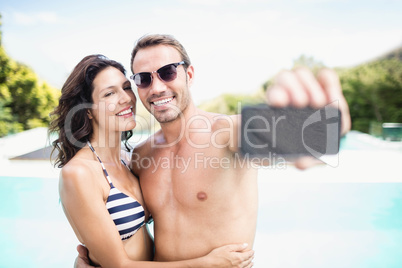 Young couple taking selfie with mobile phone