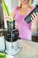 Woman preparing a smoothie in the kitchen