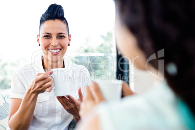 Lesbian couple having a cup of coffee