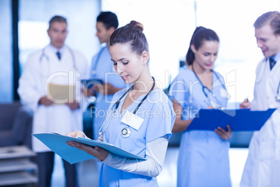 Female doctor checking medical report