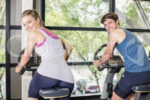 Fit people doing exercise bike