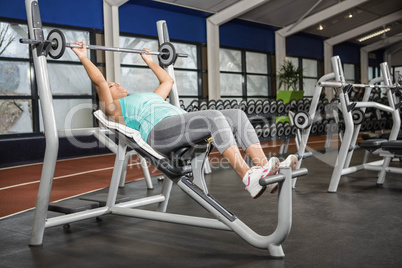 Pregnant woman lifting barbell