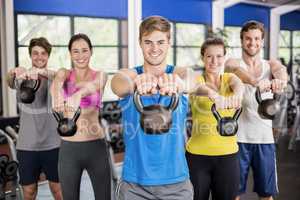 Fitness class lifting dumbbells