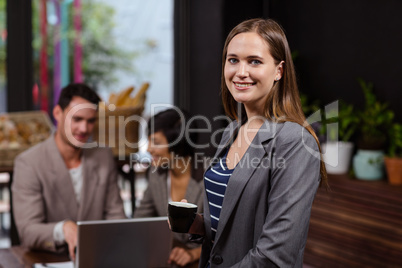 Smiling woman holding a cup of coffee Smiling woman holding a cup of coffee