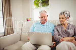 Senior couple looking at laptop