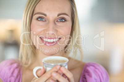 Pretty blonde woman having coffee