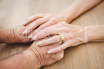 Senior couple holding hands