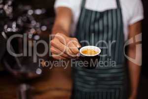 Barista offering an espresso