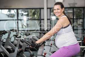 Pregnant woman using exercise bike