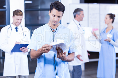 Doctor checking medical report in hospital