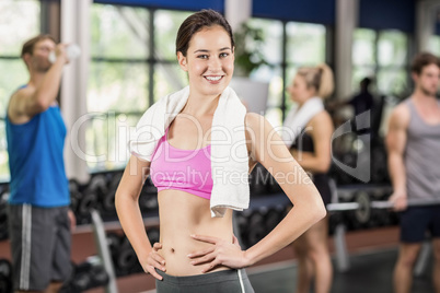 Fit woman posing with athletic women and man behind