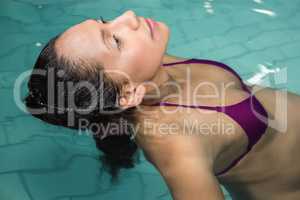 Pregnant woman floating in the pool
