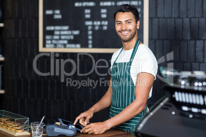 Pretty barista using cash register