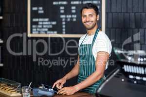 Pretty barista using cash register