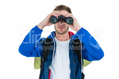 Backpacker hipster looking through binoculars