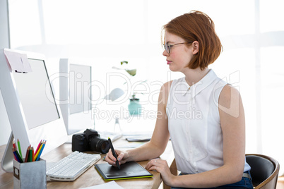 beautiful hipster woman drawing at her desk