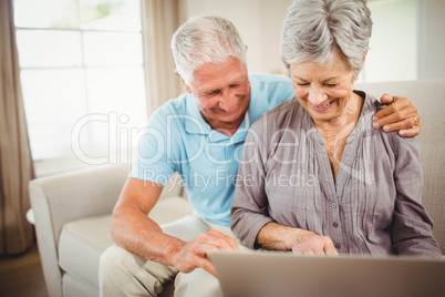 Senior couple looking at laptop