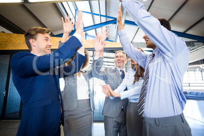 Happy business team high fiving