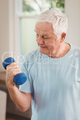 Senior man exercising with dumbbells