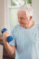 Senior man exercising with dumbbells