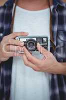View of masculine hands holding a retro camera
