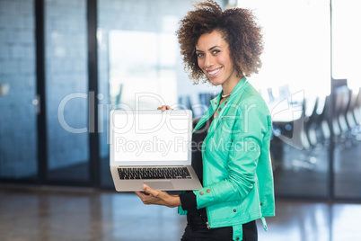 Young woman using laptop in office