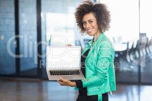 Young woman using laptop in office