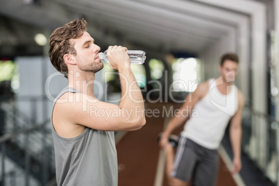 Fit man drinking water