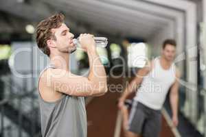 Fit man drinking water