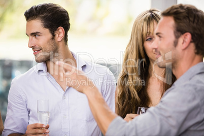 Friends having champagne and talking to each other