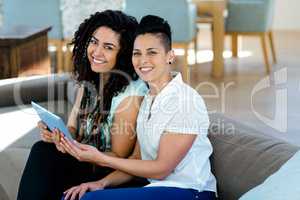 Lesbian couple using digital tablet