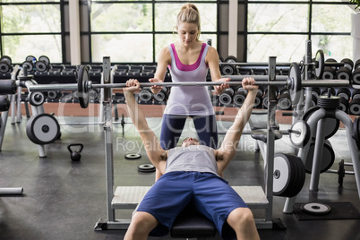 Trainer woman helping athletic man