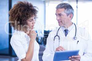 Doctor and colleague looking in digital tablet