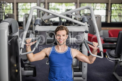 Fit man using weight machine