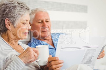 Senior couple reading newspaper