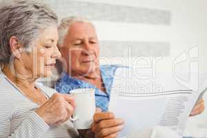 Senior couple reading newspaper