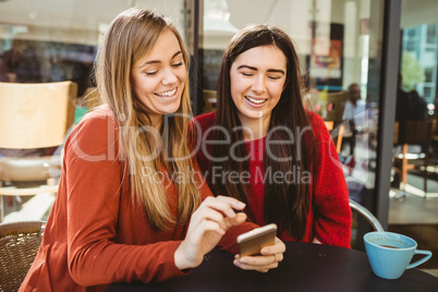 Friends looking at smartphone