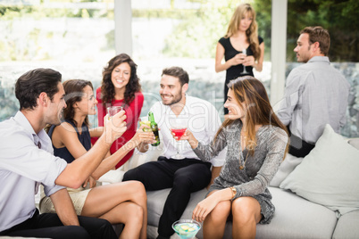 Group of friends talking and having drinks