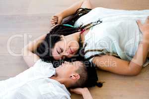 Lesbian couple lying on wooden floor