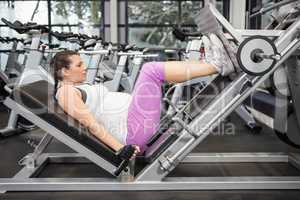 Pregnant woman using weight machine