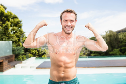 Young man smiling near poolside