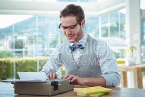 Handsome man using old fashioned typewriter