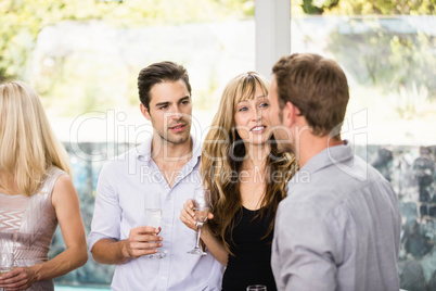 Group of friends talking and having drinks